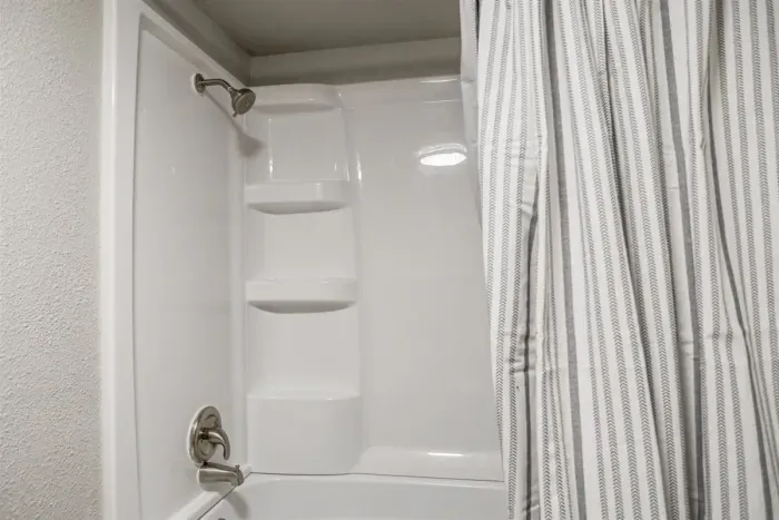 Clean and modern bathroom with a large shower, soft towels, and complimentary toiletries to make your stay more comfortable.
