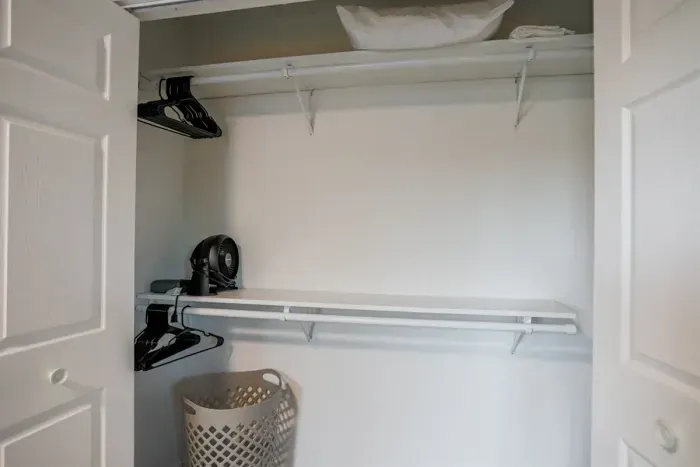 Spacious closet with shelves and hangers, offering ample room for your clothing and belongings, perfect for an organized stay.