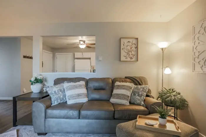Cozy and inviting living room with comfortable seating and a modern design, perfect for relaxing after a day exploring Schofield. Enjoy high-speed Wi-Fi and streaming services on the large flat-screen TV.