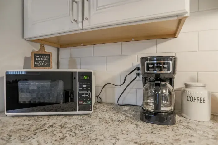 Fully equipped kitchen with stainless steel appliances, perfect for cooking homemade meals during your stay. Enjoy the convenience of a coffee maker, microwave, and a large refrigerator.