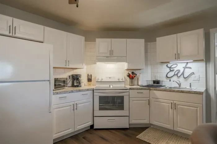Fully equipped kitchen with stainless steel appliances, perfect for cooking homemade meals during your stay. Enjoy the convenience of a coffee maker, microwave, and a large refrigerator.