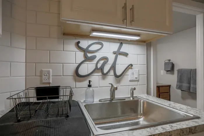 Fully equipped kitchen with stainless steel appliances, perfect for cooking homemade meals during your stay. Enjoy the convenience of a coffee maker, microwave, and a large refrigerator.