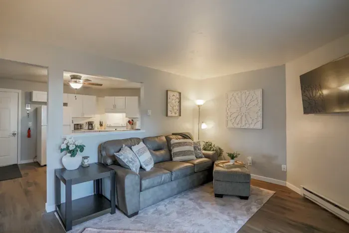 Cozy and inviting living room with comfortable seating and a modern design, perfect for relaxing after a day exploring Schofield. Enjoy high-speed Wi-Fi and streaming services on the large flat-screen TV.