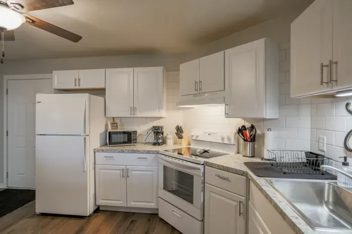 Fully equipped kitchen with stainless steel appliances, perfect for cooking homemade meals during your stay. Enjoy the convenience of a coffee maker, microwave, and a large refrigerator.