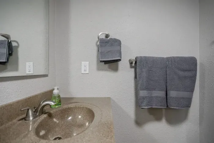 Clean and modern bathroom with a large shower, soft towels, and complimentary toiletries to make your stay more comfortable.