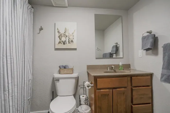 Clean and modern bathroom with a large shower, soft towels, and complimentary toiletries to make your stay more comfortable.