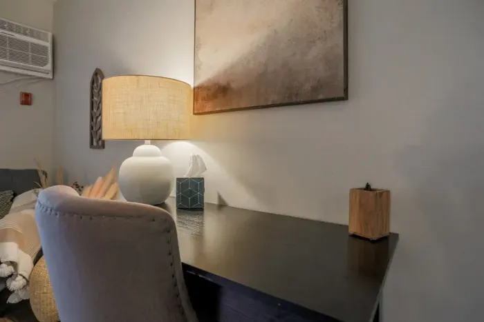 Cozy and inviting living room with comfortable seating and a modern design, perfect for relaxing after a day exploring Schofield. Enjoy high-speed Wi-Fi and streaming services on the large flat-screen TV.