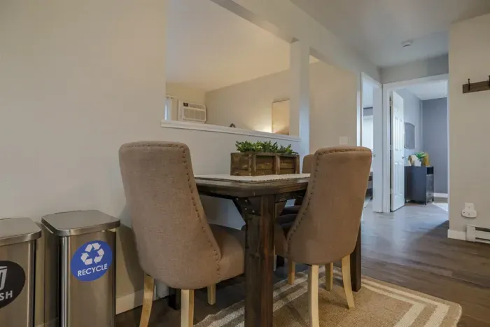 Cozy and inviting living room with comfortable seating and a modern design, perfect for relaxing after a day exploring Schofield. Enjoy high-speed Wi-Fi and streaming services on the large flat-screen TV.