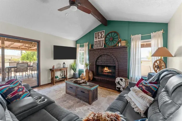 Gather around the cozy fireplace or settle into the plush leather sofa for movie night. With bright windows and rustic décor, this living space offers the perfect place to relax and recharge.