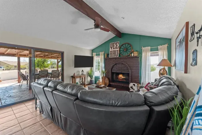Enjoy a bright and comfortable living space with a vaulted ceiling, warm fireplace, and inviting seating. It's the ideal spot to relax, watch TV, or spend quality time together.