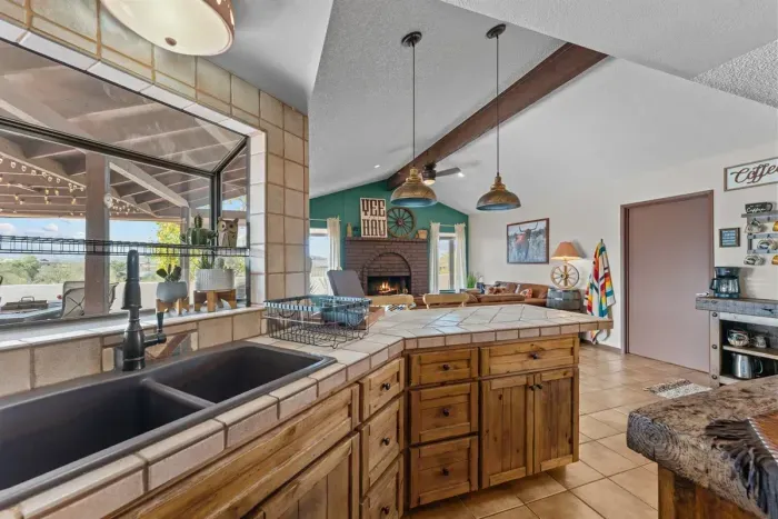 Modern and efficient—everything you need to create a delicious meal. The kitchen features a stainless steel refrigerator, stove, coffee maker, kitchenette oven, kettle, and blender.