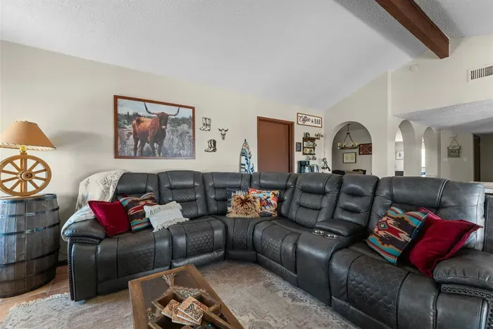 Settle into the plush leather sofa for movie night or relax with a good book. With natural light and cozy decor, this living space is perfect for recharging after a day out.