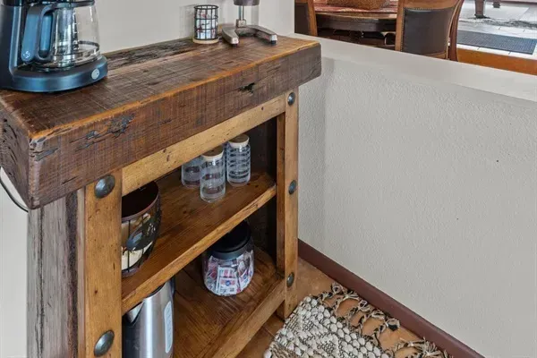 Modern and efficient—everything you need to create a delicious meal. The kitchen features a stainless steel refrigerator, stove, coffee maker, kitchenette oven, kettle, and blender.