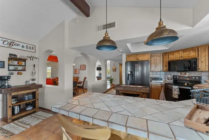 Modern and efficient—everything you need to create a delicious meal. The kitchen features a stainless steel refrigerator, stove, coffee maker, kitchenette oven, kettle, and blender.