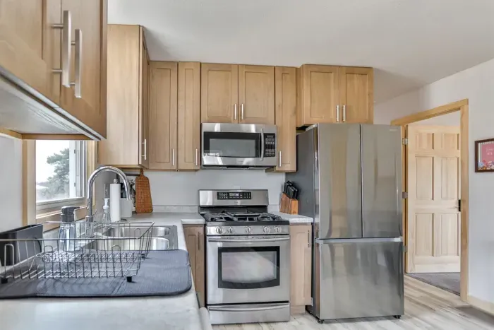Compact kitchen with complete cookware and convenient layout.