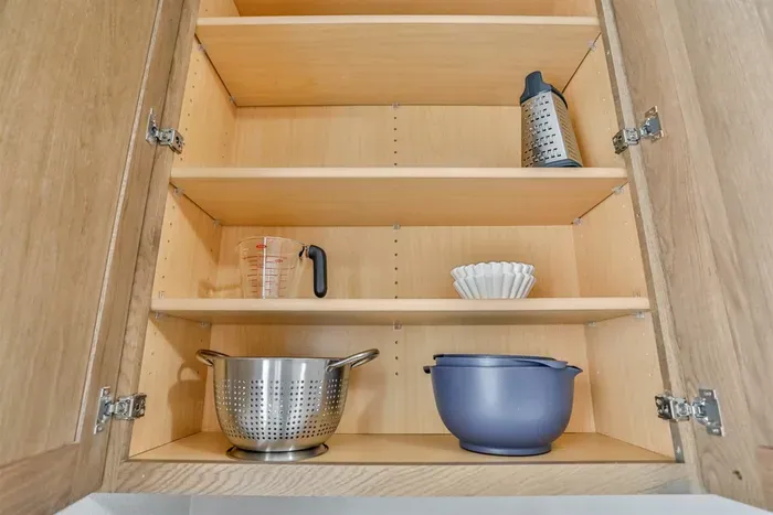 Well-equipped kitchen with cookware, utensils, and modern appliances.