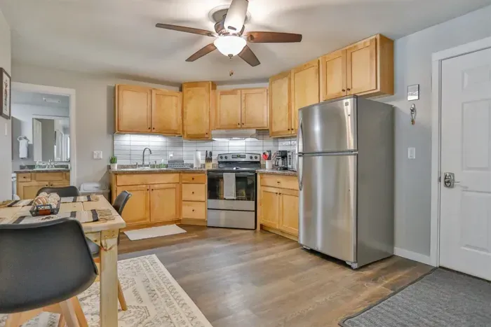 Modern and practical—everything you need to create a tasty meal. Kitchen includes a stainless steel refrigerator, stove, coffee maker, and kitchenette oven.