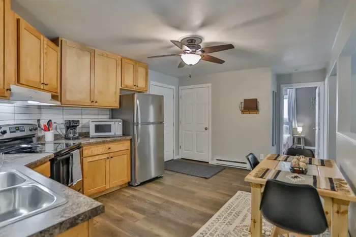 Modern and practical—everything you need to create a tasty meal. Kitchen includes a stainless steel refrigerator, stove, coffee maker, and kitchenette oven.