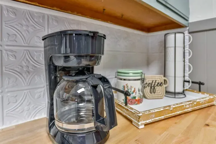 Start your mornings right with our coffee maker, stocked and ready for a comforting cup of coffee.