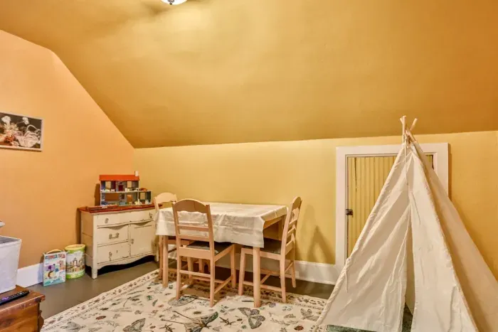 Cozy children’s play area designed for both fun and relaxation. The space features a dedicated table for games, crafts, making it a perfect kid-friendly space.