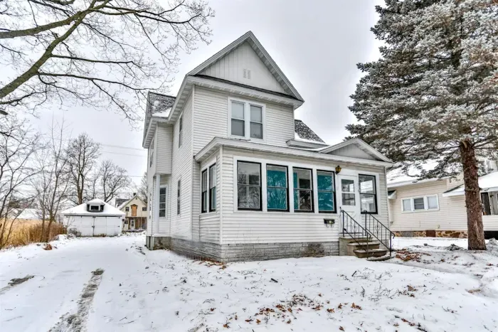 Charming two-story home with classic curb appeal, featuring a bright enclosed front porch, this cozy retreat offers a welcoming feel in every season.