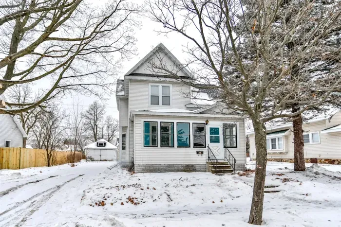 Charming two-story home with classic curb appeal, featuring a bright enclosed front porch, this cozy retreat offers a welcoming feel in every season.