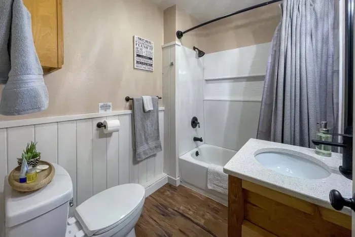 Experience modern convenience in our Airbnb with a pristine bathroom featuring a sleek toilet. Unwind in a clean and stylish space, ensuring a refreshing and comfortable stay throughout your visit.