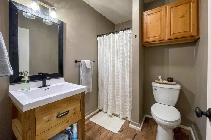 Experience modern convenience in our Airbnb with a pristine bathroom featuring a sleek toilet. Unwind in a clean and stylish space, ensuring a refreshing and comfortable stay throughout your visit.