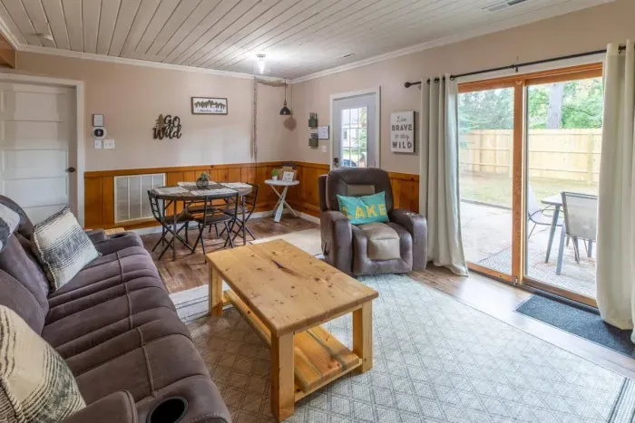 Indulge in comfort and style in our living room, featuring plush sofas, elegant chairs, and a spacious eating area. Unwind with entertainment on the TV. 