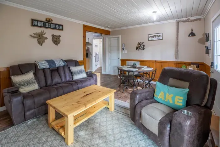 Indulge in comfort and style in our living room, featuring plush sofas, elegant chairs, and a spacious eating area. Unwind with entertainment on the TV. 