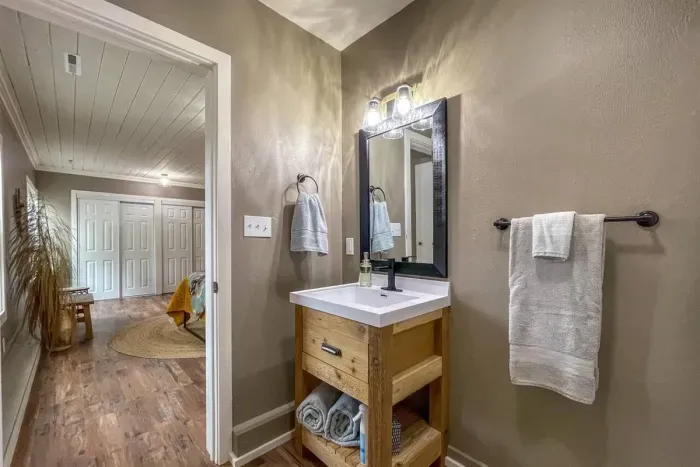 Experience modern convenience in our Airbnb with a pristine bathroom featuring a sleek toilet. Unwind in a clean and stylish space, ensuring a refreshing and comfortable stay throughout your visit.
