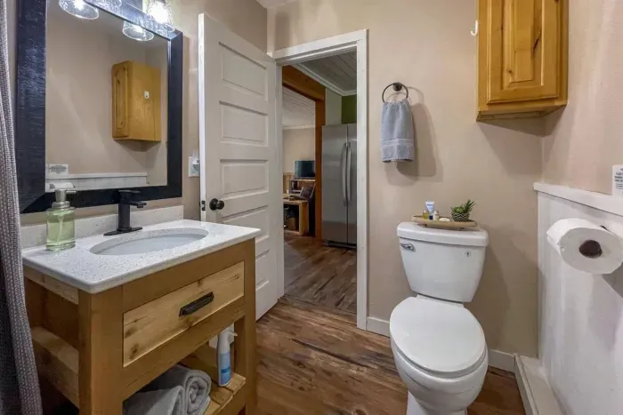 Experience modern convenience in our Airbnb with a pristine bathroom featuring a sleek toilet. Unwind in a clean and stylish space, ensuring a refreshing and comfortable stay throughout your visit.