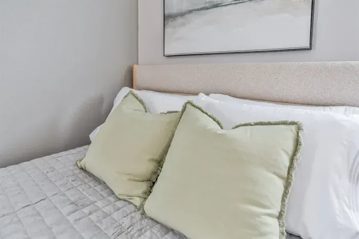 Relaxing bedroom space with modern decor, comfy mattress, and serene atmosphere.