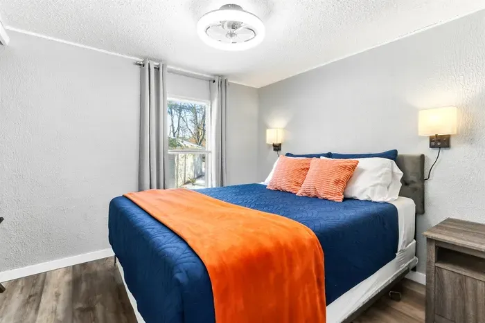 Stylish bedroom with a queen bed and serene atmosphere.