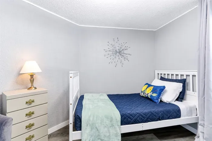 Stylish bedroom with a bed, couch, and practical drawers.