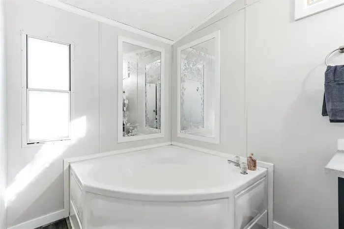 Relaxing bathroom with soaking tub and natural light.