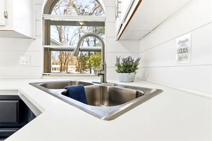 Functional kitchen with a double sink, combining style and practicality.