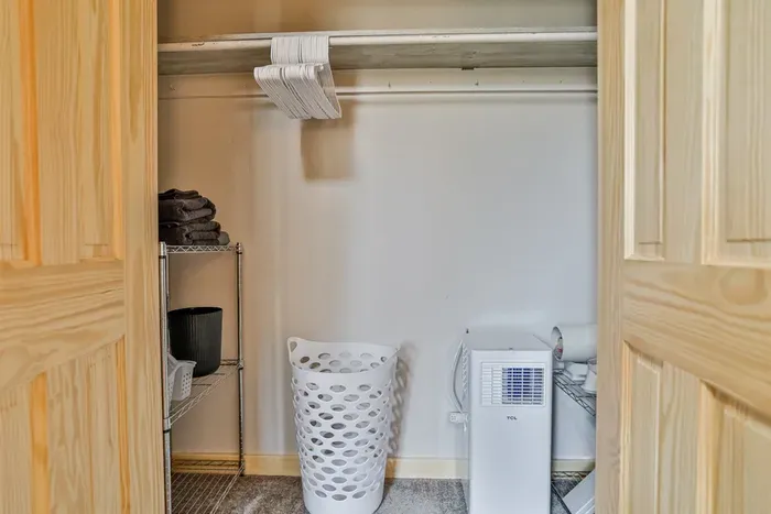 Simple yet stylish bedroom with comfortable bed, fresh air, and a homey feel.