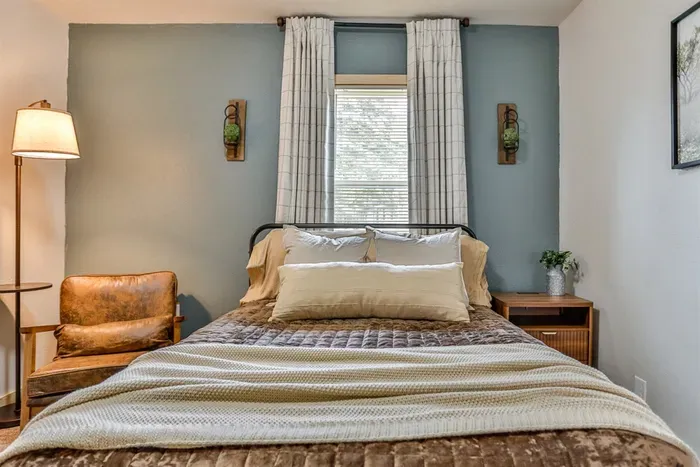 Elegant bedroom with hotel-quality bedding and a warm, relaxing ambiance.