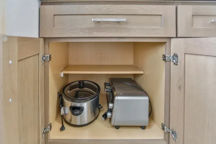 Compact kitchen with complete cookware and convenient layout.