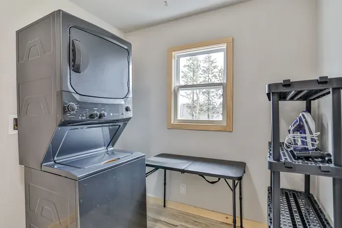 Simple laundry setup with washer available for guest use.