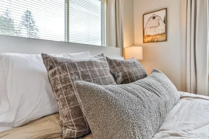 Minimalist bedroom retreat with soft bedding, clean design, and quiet surroundings.