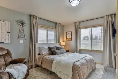Bright and stylish bedroom featuring plush linens, and a peaceful vibe.