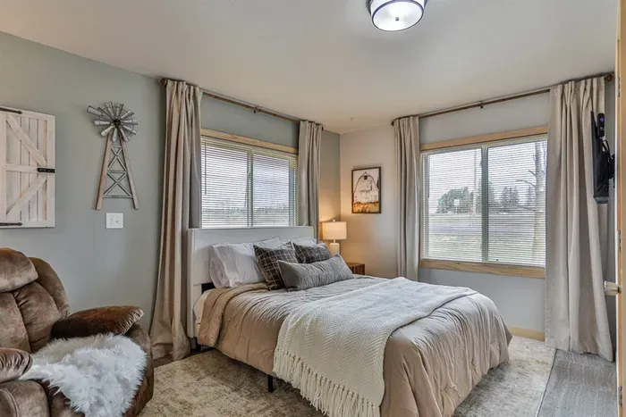 Bright and stylish bedroom featuring plush linens, and a peaceful vibe.