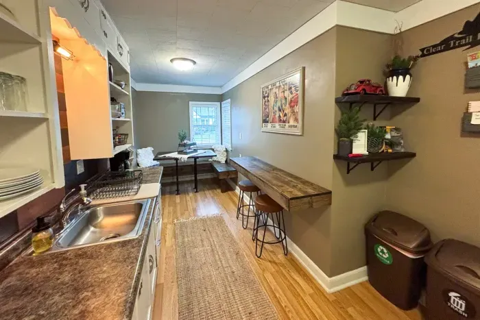 Modern and efficient—everything you need to create a delicious meal. The kitchen features a stainless steel refrigerator, stove, coffee maker, kitchenette oven, kettle, and blender