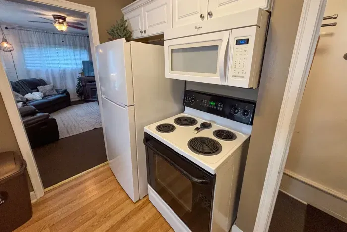 Modern and efficient—everything you need to create a delicious meal. The kitchen features a stainless steel refrigerator, stove, coffee maker, kitchenette oven, kettle, and blender