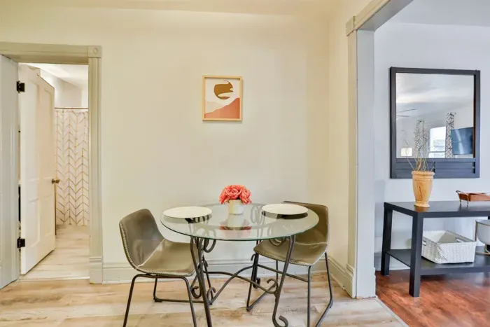 A modern kitchen equipped with high-end appliances and ample lighting. It has a coffee maker, oven, stove top, utensils, and all it takes to fix a delicious meal.