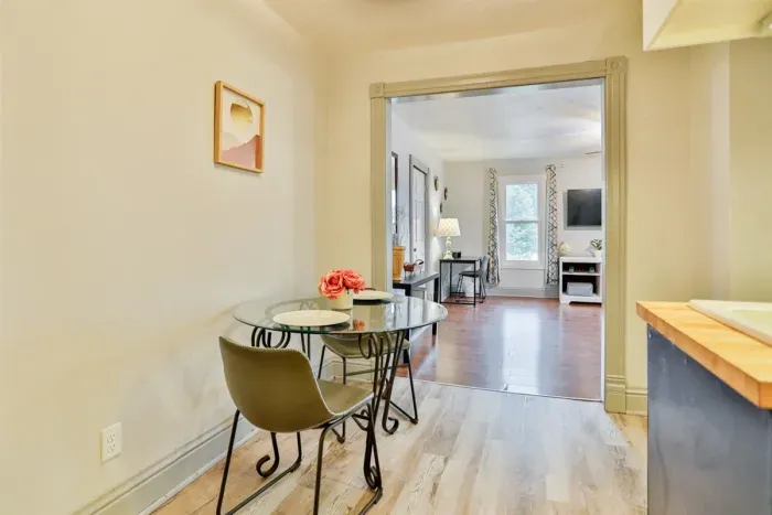 A modern kitchen equipped with high-end appliances and ample lighting. It has a coffee maker, oven, stove top, utensils, and all it takes to fix a delicious meal.