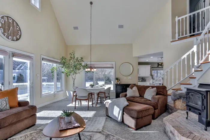A spacious shared living area featuring a cozy couch and a dining area, creating a welcoming space for both lounging and dining.