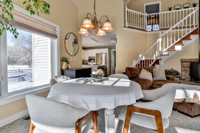 The living room features a dining table, perfect for shared meals, coffee, or planning your day together.